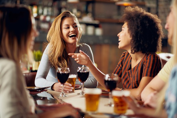 Smiling women drinking wine