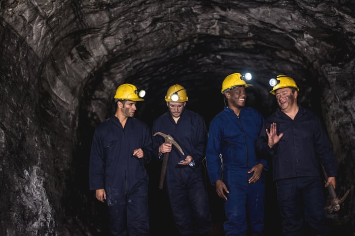 A group of people in protective gear in a mine.