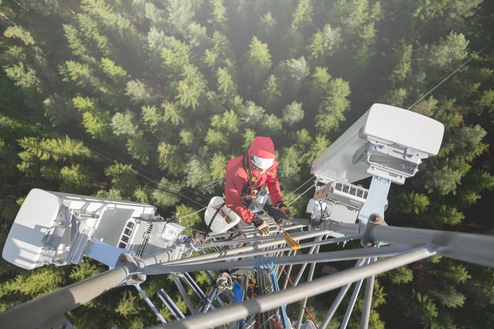 Worker climbing a cell tower.