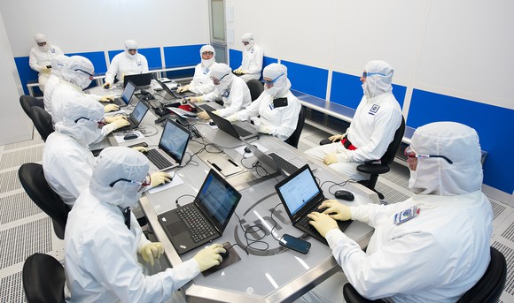 Intel engineers wearing bunny suits in a lab.