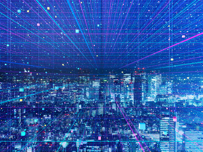 A cityscape at night, covered in digital color streaks.