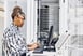 Information technology professional working in a server room with a laptop