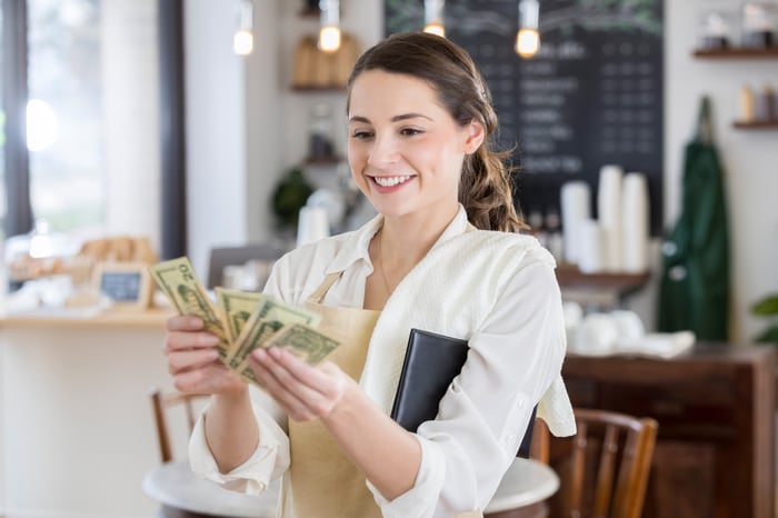 Worker counting and enjoying cash income.