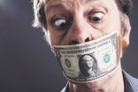 Scared man with Dollar Bill over Face -- GettyImages-1298650482