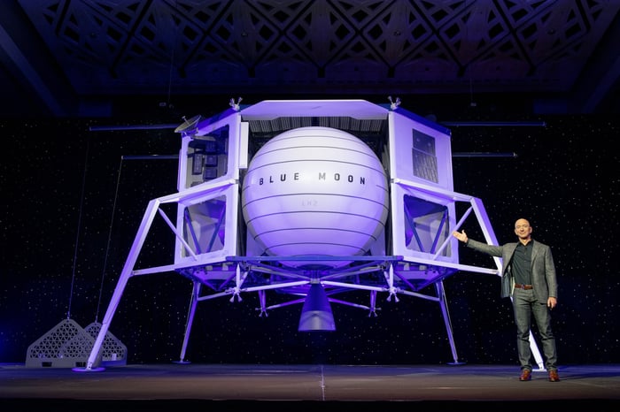 Jeff Bezos gesturing to a model of his Blue Moon lunar lander.