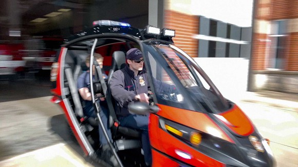 Arcimoto's Rapid Responder three-wheeled electric vehicle leaving fire station.