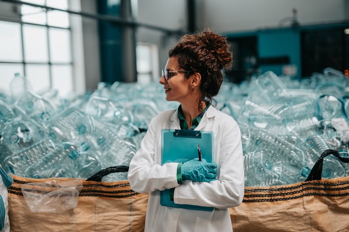 A worker in a plastic bottle recycling facility.