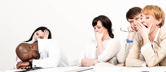 Group of people yawning, falling asleep in a meeting.