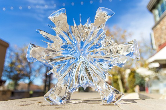 Ice shaped like a snowflake melting in the sun