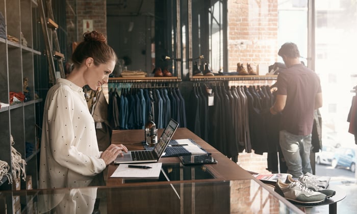 Two people in a luxury clothing store