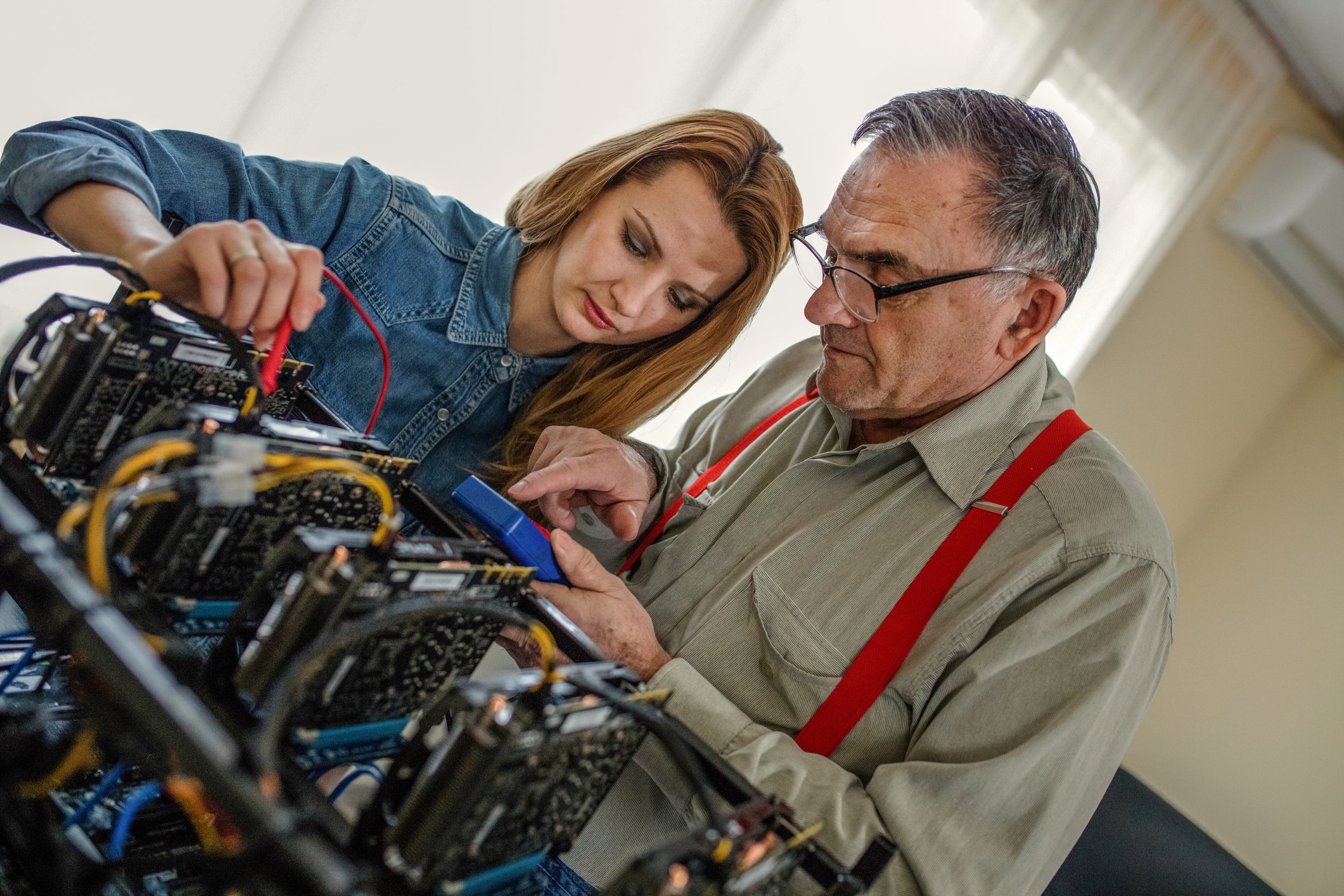 Two programmers working on a cryptocurrency mining setup