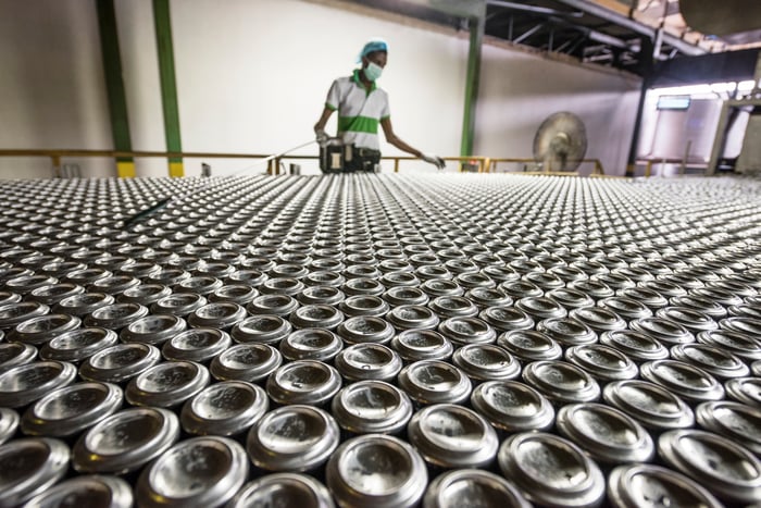 A person working in an aluminum can processing plant.