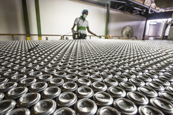 A person working in an aluminum can processing plant.