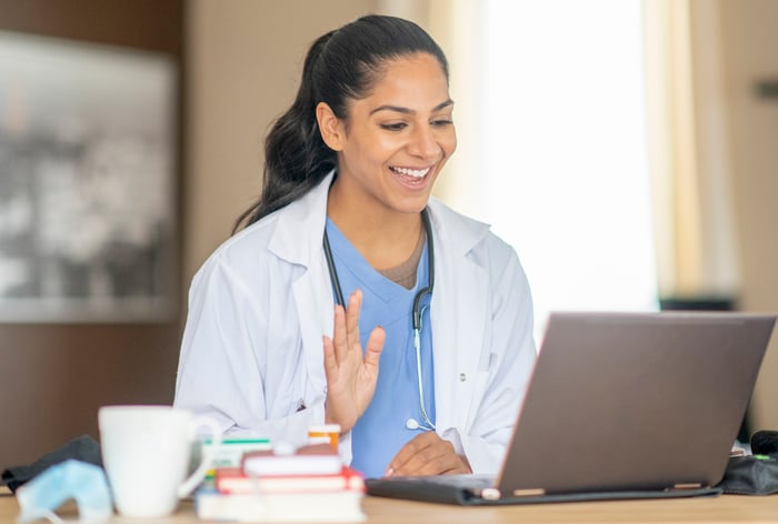 Physician consulting with a patient using Teladoc's virtual platform.