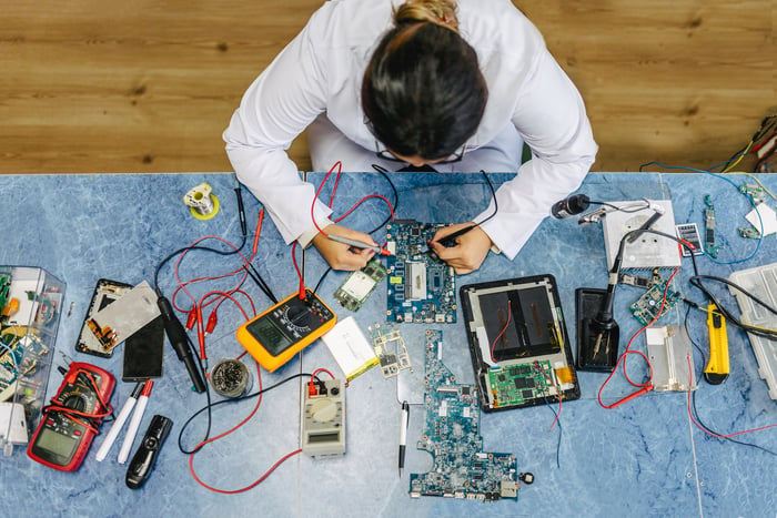 An electronic engineer working on integrated circuit boards.