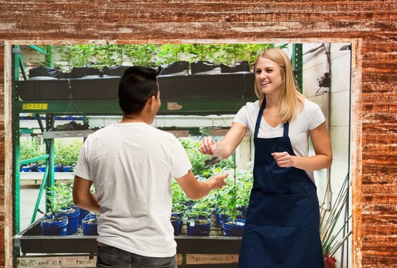 A customer and employee conduct business at a hydroponics store.