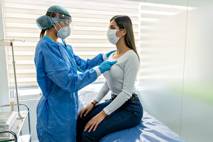 Person being examined by doctor.