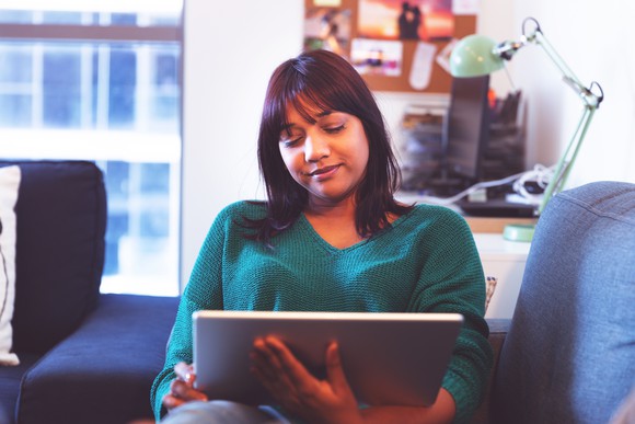 An office worker utilizes software on a large tablet.