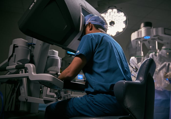 A surgeon at the control console of one of Intuitive's robotic-surgery products.