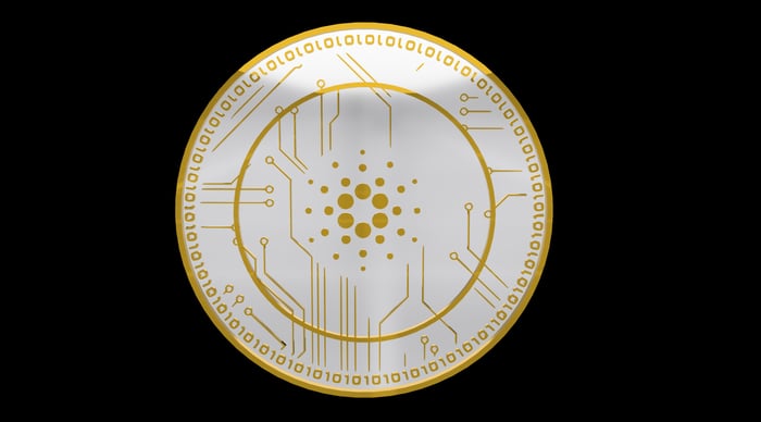 A golden ADA coin with binary digits inscribed on its outer ring. 