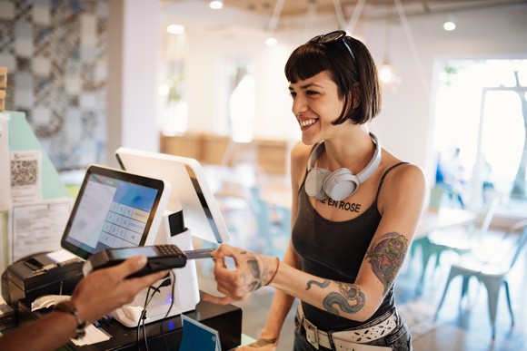 Person paying with card at a restaurant.