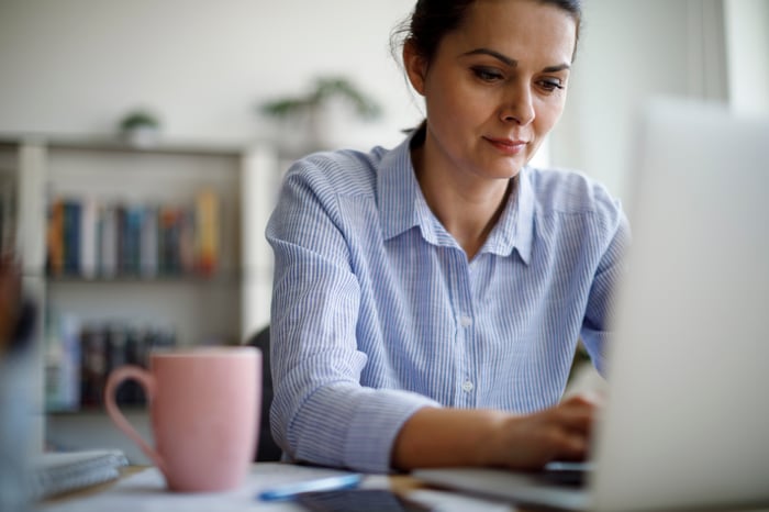 Person sitting in front of a laptop.