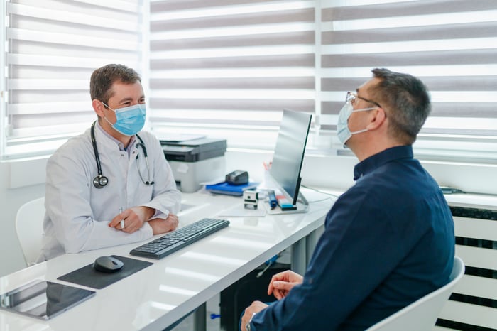 A doctor and a patient meet for an appointment.