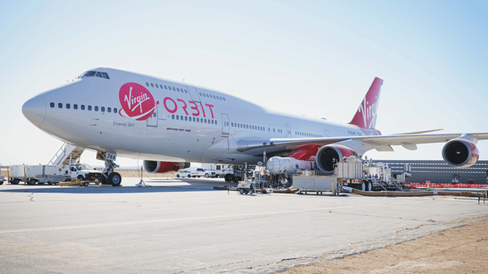 Cosmic Girl mothership with LauncherOne rocket on the tarmac.