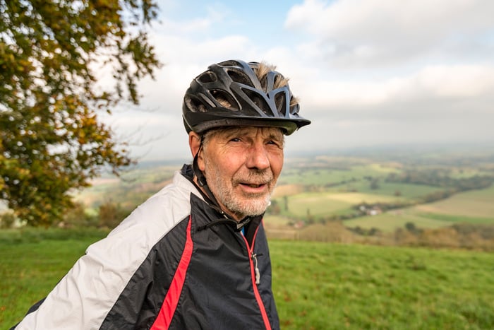 Person outdoors wearing bike helmet.