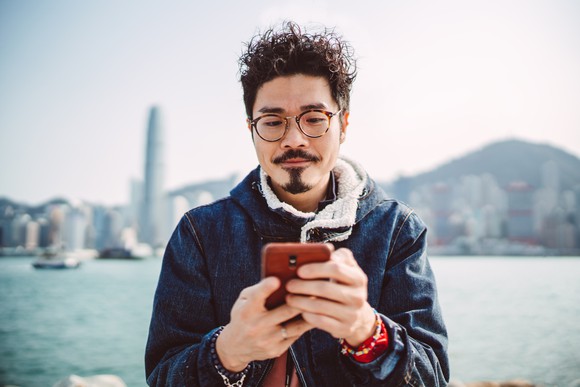 A smartphone user types a message.