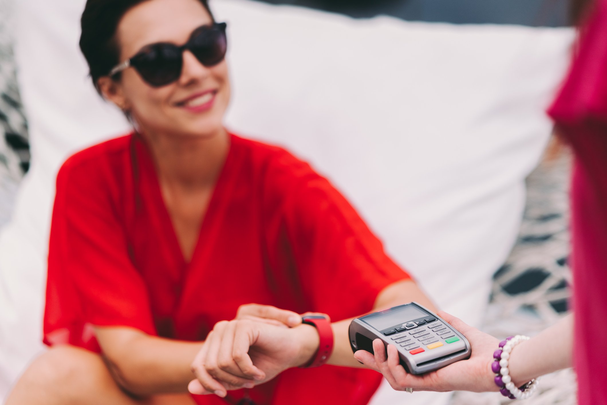 A person and another person holding a credit card processor.