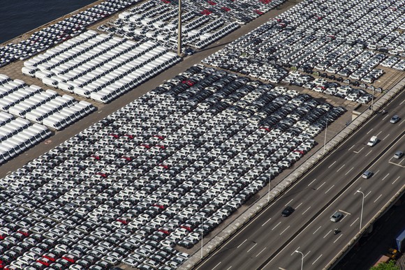 An aerial view of cars and trucks parked after manufacture, awaiting shipment.