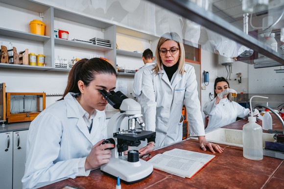 Three scientists working in a biotechnology laboratory.