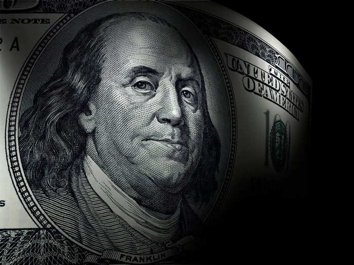 Ben Franklin's portrait on a one hundred dollar bill. 