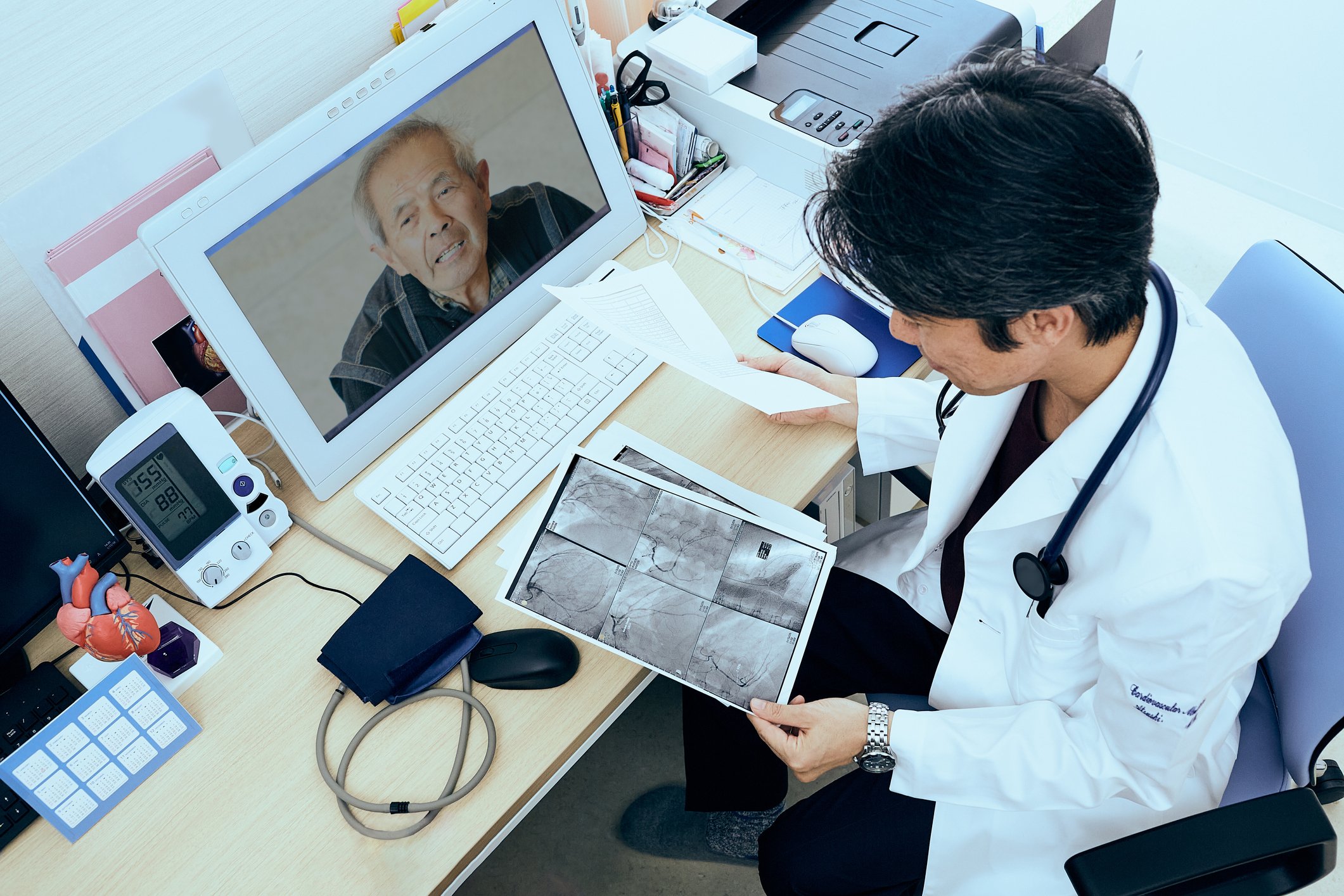 Doctor going over X-rays with patient via telehealth