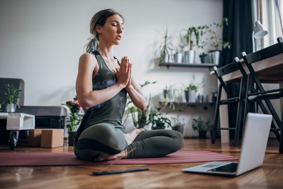 Woman wearing athletic apparel, doing yoga.