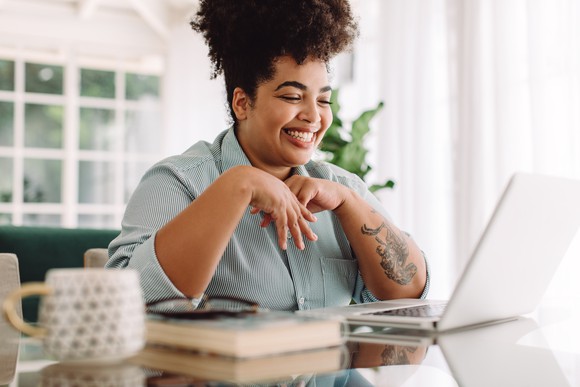 Happy person looking at work computer.