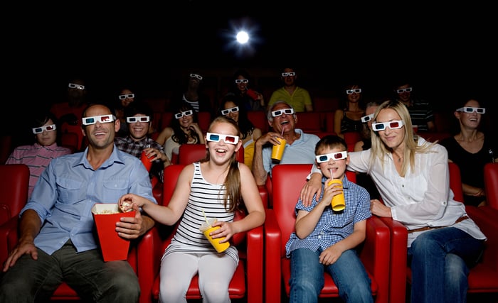 A group of people watching a movie in a movie theater.