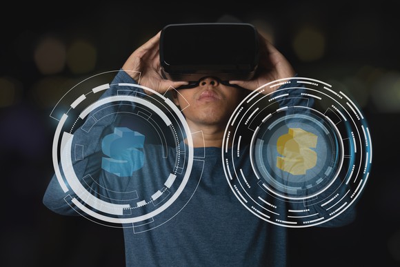 A person holding virtual reality goggles with images of dollar signs in the foreground.