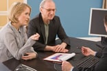 Senior couple investing discussion -- GettyImages-81284593