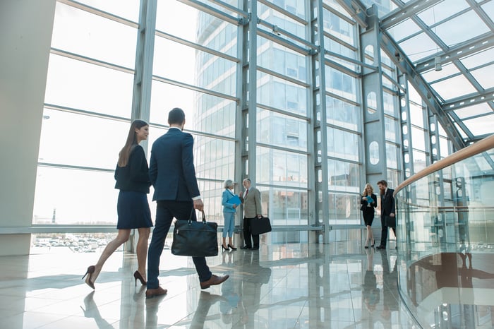 People walking in the atrium of an office building.