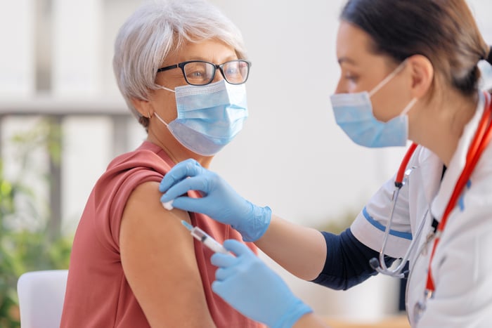 A senior woman receives a vaccination to protect against COVID-19.