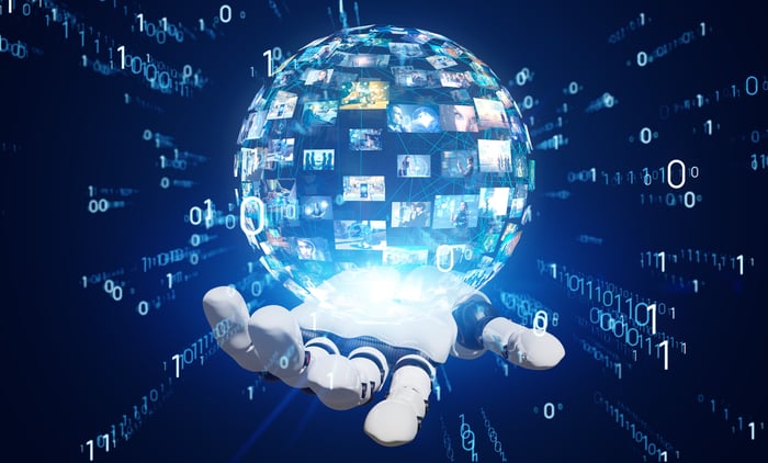 A robotic hand holds a ball of video images, surrounded by digital numbers.