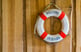 Life preserver reading WELCOME ON BOARD hangs on a wall