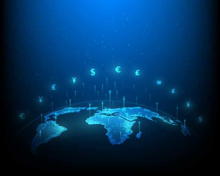 A graphic of a globe with various currency icons floating above.