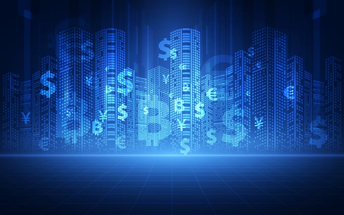 Currency and crypto images on a digital wall.