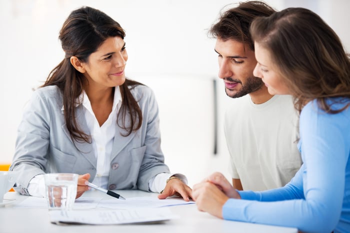 Young couple having a discussion with a financial consultant.