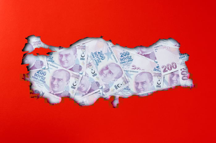 Map of Turkey filled in with 200-lira notes on a red background.