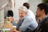 Senior worker speaking with younger colleague -- GettyImages-926404312