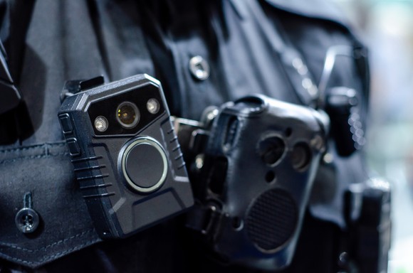 A close-up of a police officer wearing a body camera.